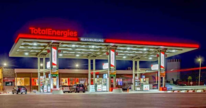 A TotalEnergies fuel station illuminated at night, showcasing the company’s retail network presence.