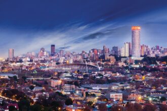 Evening skyline of Johannesburg, South Africa, showcasing the city’s financial district and urban landscape.