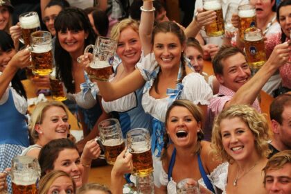 Revelers raise beer steins during Oktoberfest celebrations.