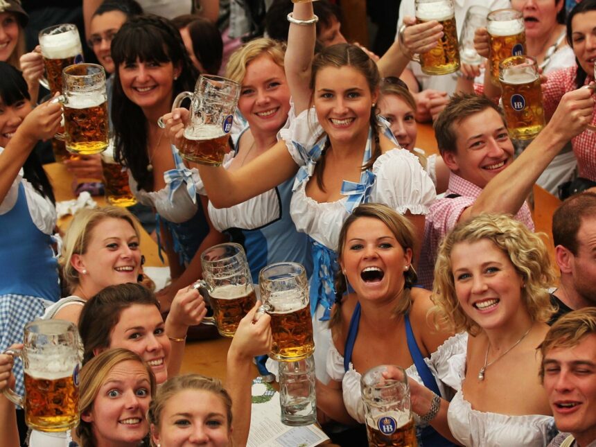 Revelers raise beer steins during Oktoberfest celebrations.