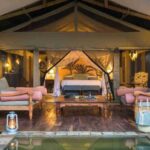 A luxury riverside safari lodge at sunset in Uganda’s Murchison Falls National Park.