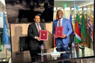 ICIEC and Afreximbank officials shake hands in Cairo, marking new partnership to boost Arab–Africa trade and digital finance platforms