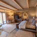 A luxury suite at Kapama River Lodge featuring modern decor, natural textures, and views of the South African bushveld.