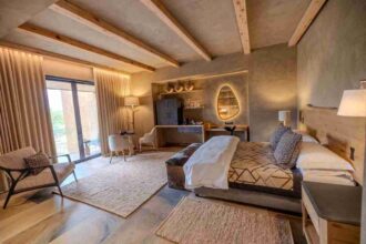 A luxury suite at Kapama River Lodge featuring modern decor, natural textures, and views of the South African bushveld.