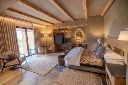 A luxury suite at Kapama River Lodge featuring modern decor, natural textures, and views of the South African bushveld.