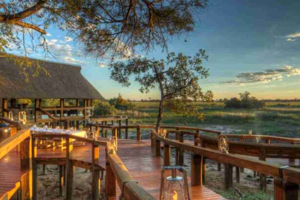 Outdoor deck at a luxury safari lodge in Botswana’s Okavango Delta overlooking floodplains at sunset.