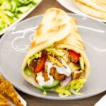 Shawarma is prepared with lamb, beef, or chicken, the meat is marinated for hours, stacked on a vertical spit, and slowly roasted