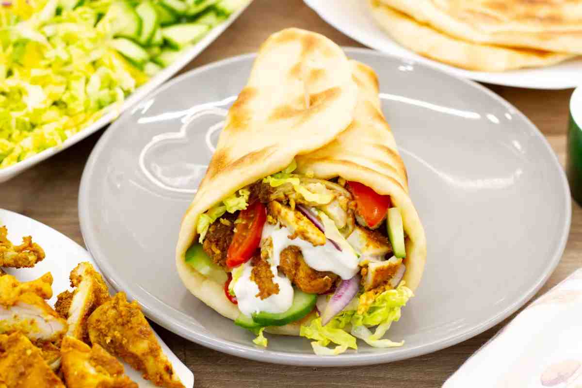 Shawarma is prepared with lamb, beef, or chicken, the meat is marinated for hours, stacked on a vertical spit, and slowly roasted