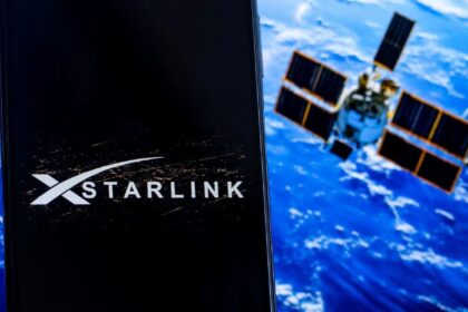 Starlink logo on a screen with planet and satellites in background