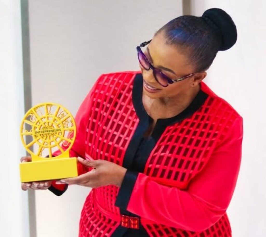 Folorunso Alakija holding the Global Entrepreneurs Award, celebrating grace, vision, purpose, and commitment.