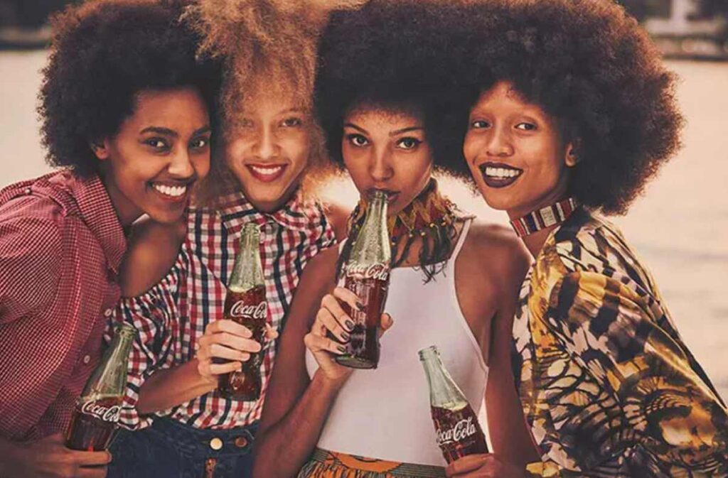 Fans enjoying Coca-Cola bottles in South Africa, reflecting the brand’s strong consumer presence and popularity.