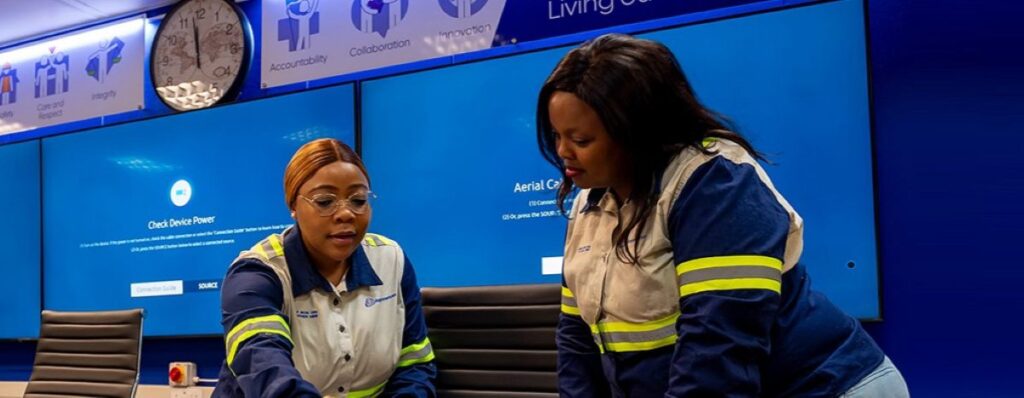 Kumba Iron Ore staff managing operations at a control station, ensuring smooth production.