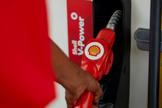 Shell logo on a fuel nozzle at a retail station.