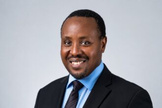 Allan Kilavuka, immediate former Group Managing Director and CEO of Kenya Airways, in an official executive portrait.