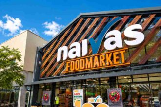 Naivas supermarket exterior featuring storefront branding, customer entrance, and modern retail expansion in Kenya.